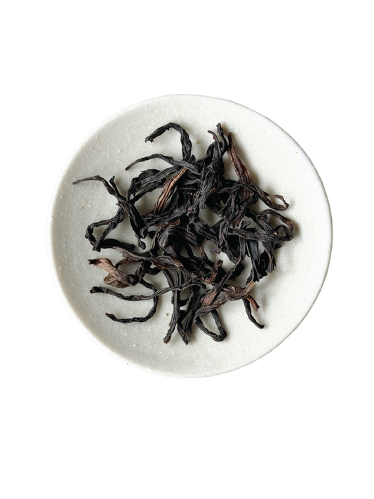 Loose-leaf twisted stripped tea leaves, dark brown to black in colour.