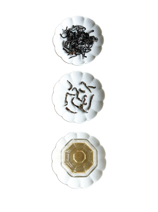 Showing the dried tea leaves, wet tea leaves and the pale golden infusion. 