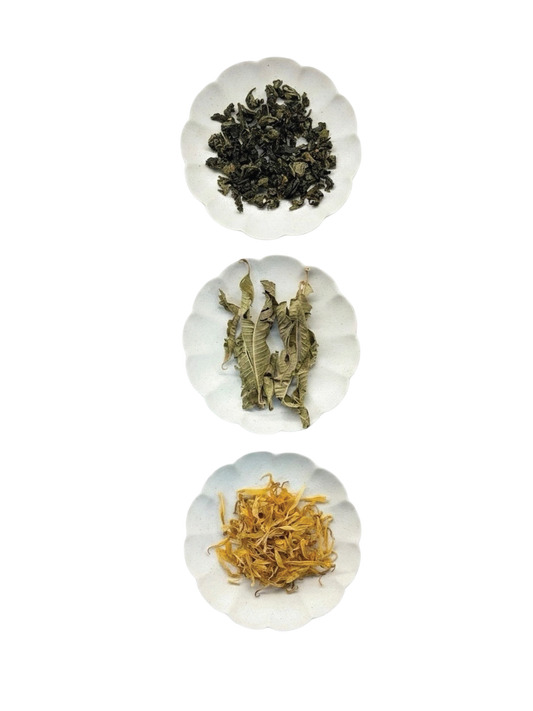 Fragrant Tie Guan Yin blended with Marigold and Lemon Verbena - showcasing the dry whole leaves and dried marigold. 